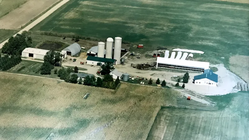Aerial view of the farm in the early 2000s, showing the new double-seven parlor and feed shed alongside the free-stall barn built by the third generation
